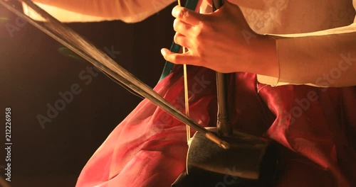 Korean female musician playing the Haegeum which is the Korean traditional string instrument on stage