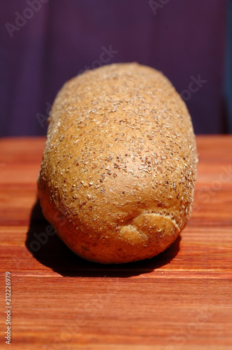 Obraz na plátně Loaf of rye bread lies on a table