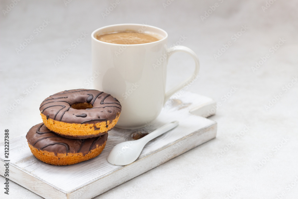 Donuts with chocolate glaze and coffee cup Donuts with chocolate glaze and coffee cup