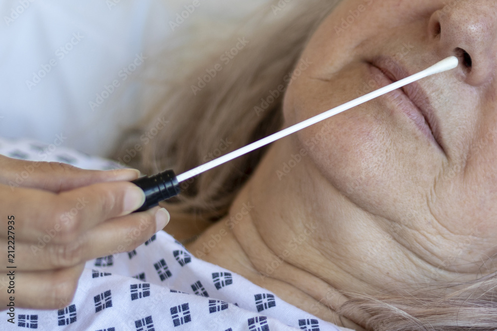 Doctor performing a nasal swab to test for MRSA super bug Stock Photo