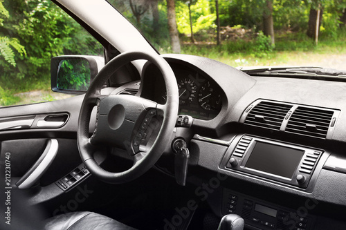View of the interior of a modern automobile showing the dashboard. Black leather car interior