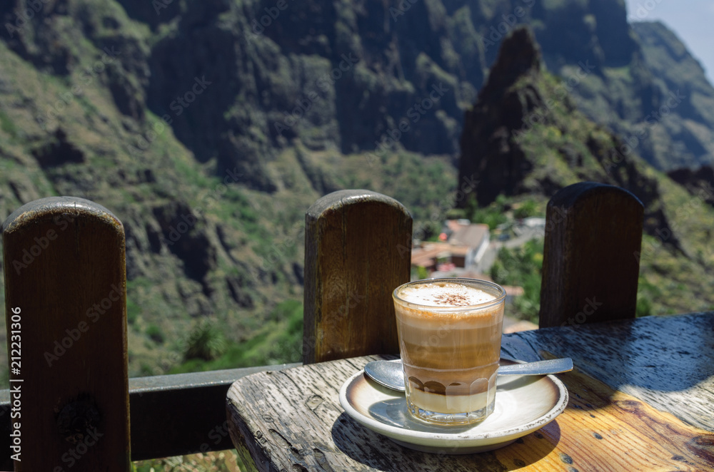 .Barraquito, typical Canarian coffee with condensed milk and liquor on terrace in Masca village in Tenerife Island, Spain..