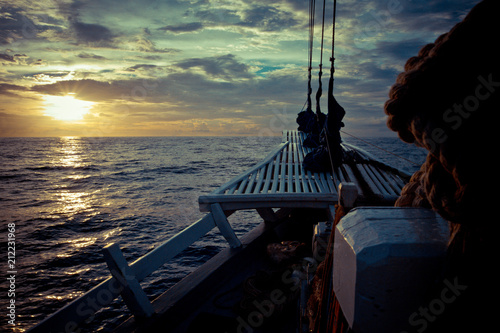 The ocean view from the bow of a sailing ship on the beautiful sunsets