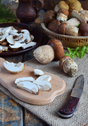 Porcini. Chopped white mushroom on wooden cutting board. Edible wild mushrooms. Food preparation. Summer or Autumn harvest. Copy space
