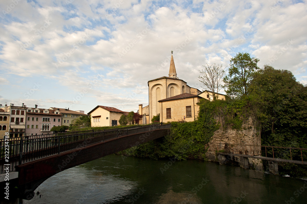 The bell tower and the cathedral of San Niccolò in Sacile on the river livenza. 
Pordenone district, Italy.