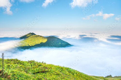 Green mountain peak in the clouds
