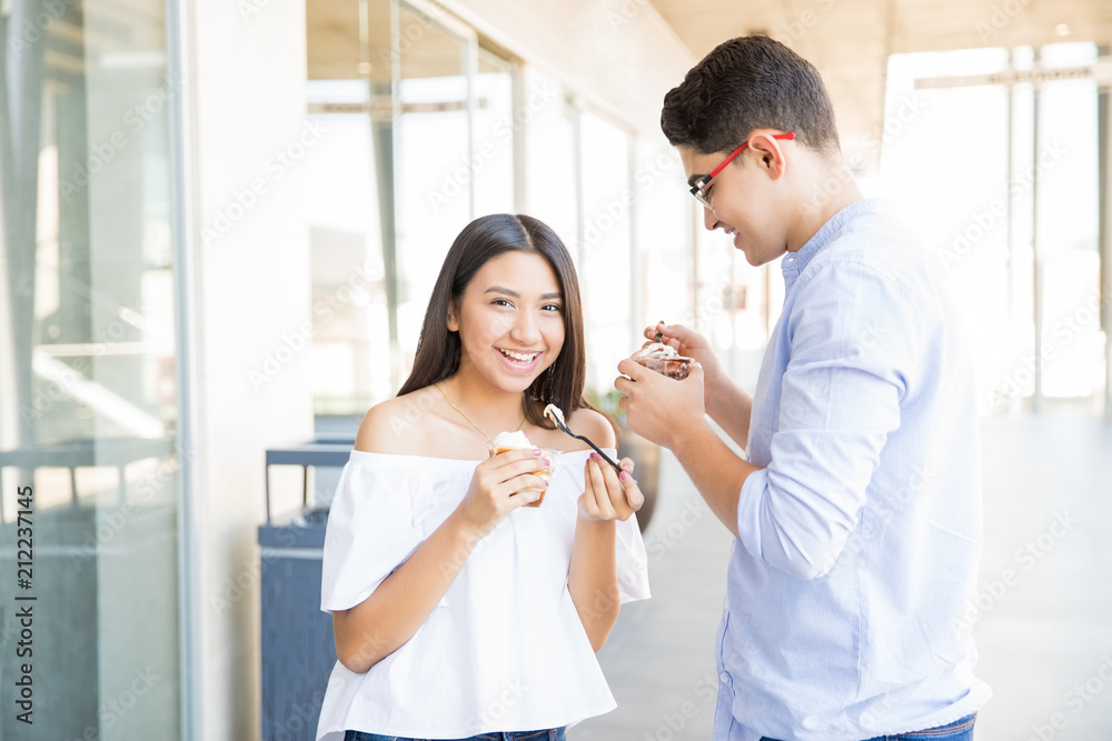 Couple Having Date And Eating Icecream In Shopping Mall Couple Having Date And Eating Icecream In Shopping Mall