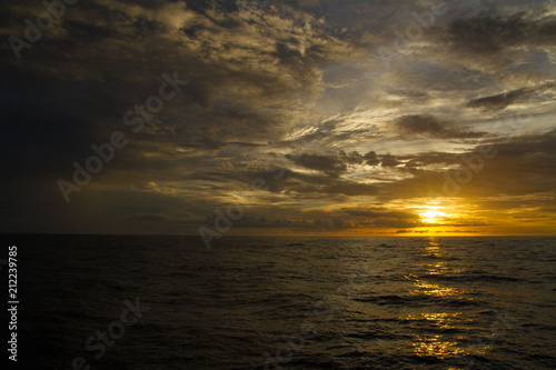 Beautiful ocean view with a dramatic sky cloud golden sunset  
