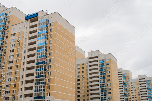 View of modern multi-storey residential buildings standing in row one after another.