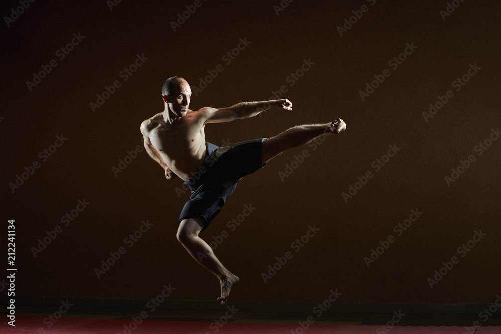 One athlete trains a kick in a jump