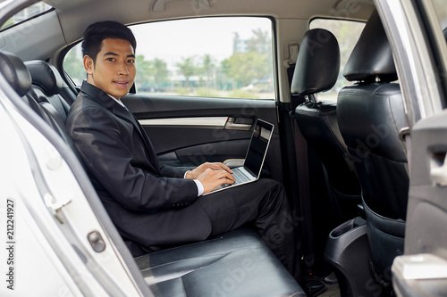 Successful businessman sitting in the back seat of a car © MIND AND I