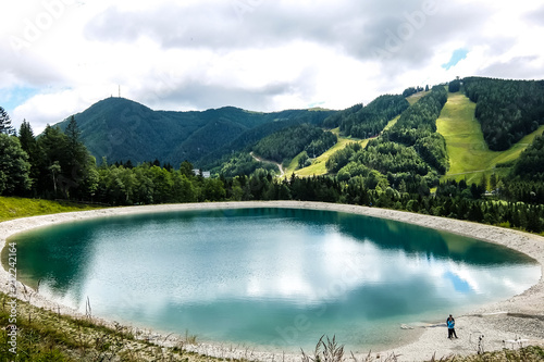 Beautiful mountain landscape with view of lake Speicherteich in the Alps of Austria on sunny summer day.