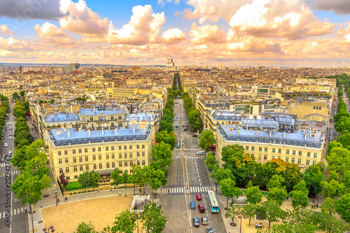 Aerial view of Paris skyline from Arc de Triomphe at sunset light. Triumphal Arch with Place de l'Etoile and Avenue de Wagram road. Paris Capital of France in Europe. Scenic urban cityscape.