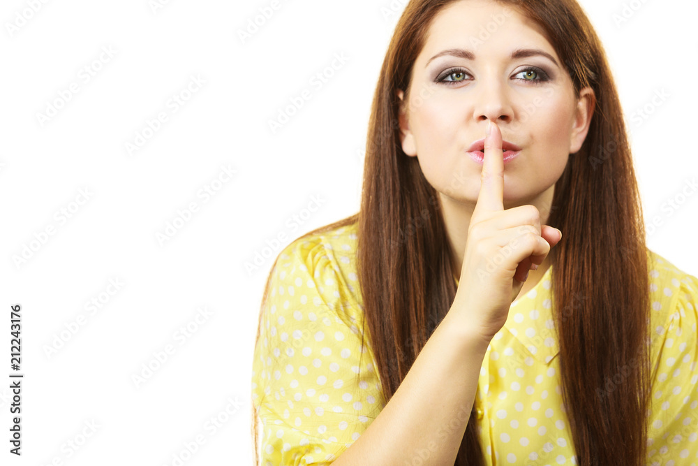 Woman asking for silence with finger on lips Woman asking for silence with finger on lips