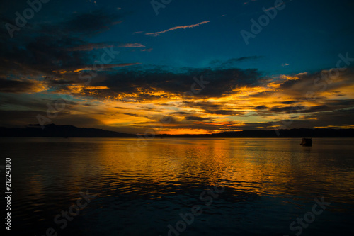 Beautiful sunrise on the calm ocean with a dramatic sky cloud golden sunrise 