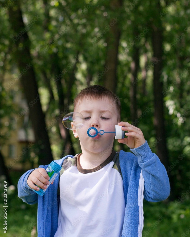 4 years Little boy with soap bubbles in summer green trees park, funny leisure time. Active kid playing in the garden on a sunny summer day, Out doors activities for children 4 years Little boy with soap bubbles in summer green trees park, funny leisure time. Active kid playing in the garden on a sunny summer day, Out doors activities for children