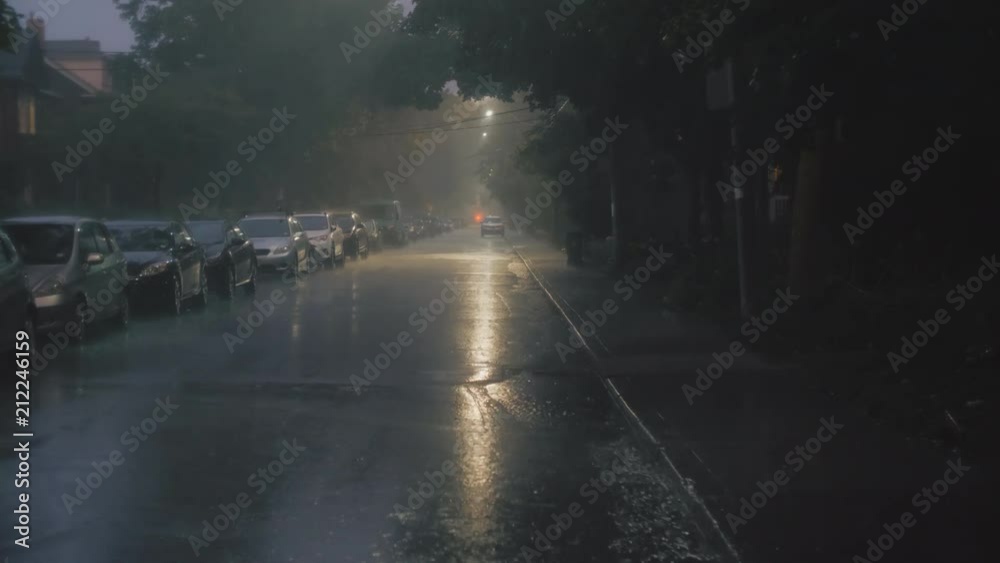 Establishing shot of a residential city street at night during an electrical storm. Cinematic 4K footage. Slow motion. Establishing shot of a residential city street at night during an electrical storm. Cinematic 4K footage. Slow motion.