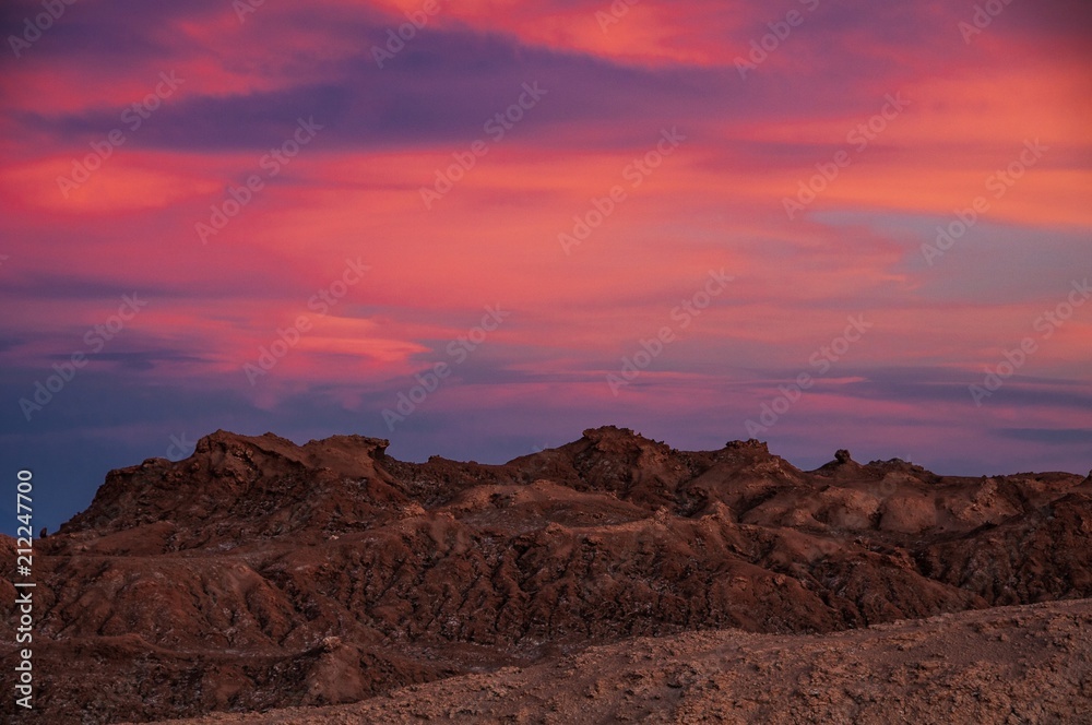 Intense hues of sunset colour in the sky at Valle de la Luna, or Moon Valley, San Pedro de Atacama, northern Chile.