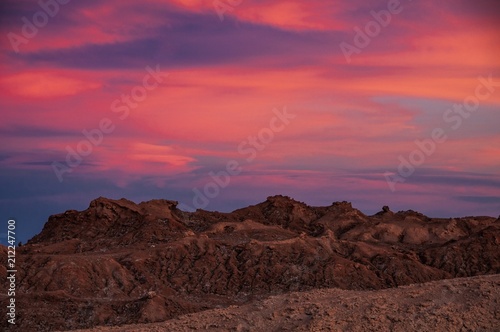 Intense hues of sunset colour in the sky at Valle de la Luna  or Moon Valley  San Pedro de Atacama  northern Chile.