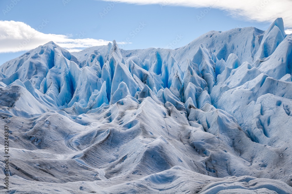 Spiky glacier peaks along the massive Perito Moreno Glacier at El Calafate, Patagonia, Argentina on a clear sunny day. These glacier peaks could be several stories high. Spiky glacier peaks along the massive Perito Moreno Glacier at El Calafate, Patagonia, Argentina on a clear sunny day. These glacier peaks could be several stories high.