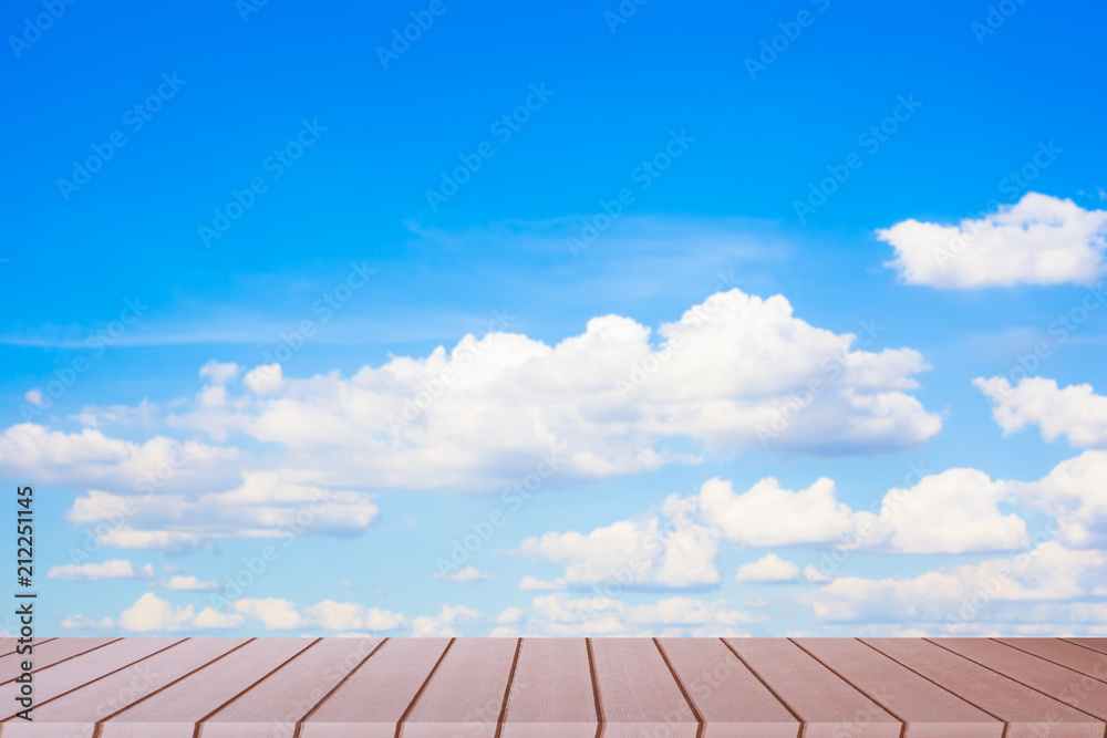 Empty wood table top on blurred blue sky background. Empty wood table top on blurred blue sky background.