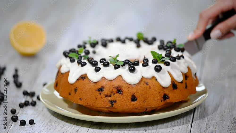 Delicate tasty cake with black currant. Cutting the cake with black currant. Delicate tasty cake with black currant. Cutting the cake with black currant.