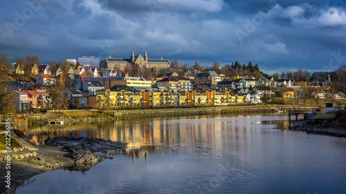 A view of Trondheim reflected in the river. Sunset before the storm. Norway