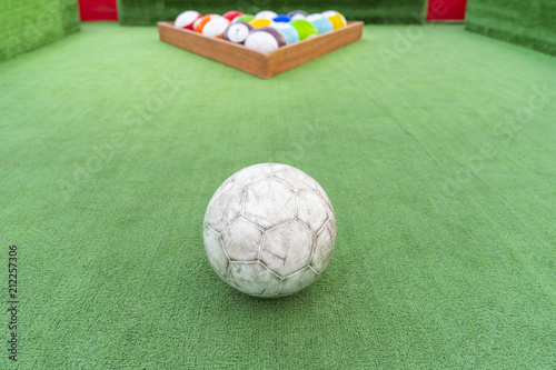 Ground pool snookball game with football balls on green grass reaching goal