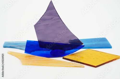 Color shattered glass pieces on white background