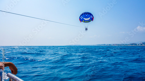 Fotografie Colorful parasail wing pulled by a boat in the sea water - Alanya, Turkey