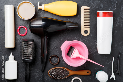 Image of hairdresser accessories on black background