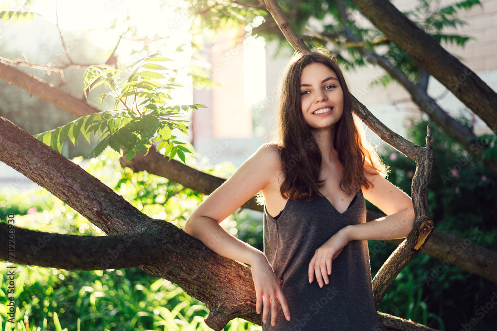 Young teen slim skinny gilr outside in the park in green trees during  sunset, clean skin Stock Photo | Adobe Stock