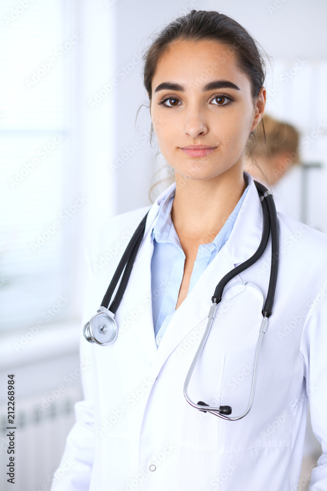 Portrait of young doctor woman in hospital. Hispanic or latin american staff in medicine Portrait of young doctor woman in hospital. Hispanic or latin american staff in medicine