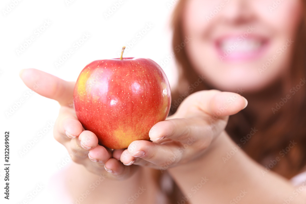 Woman holds red apple, focus on fruit Woman holds red apple, focus on fruit