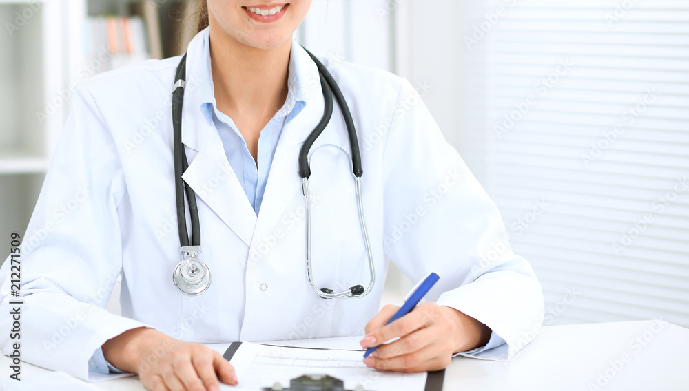 Doctor woman working at hospital. Closeup of stethoscope. Health care, insurance and help concept Doctor woman working at hospital. Closeup of stethoscope. Health care, insurance and help concept