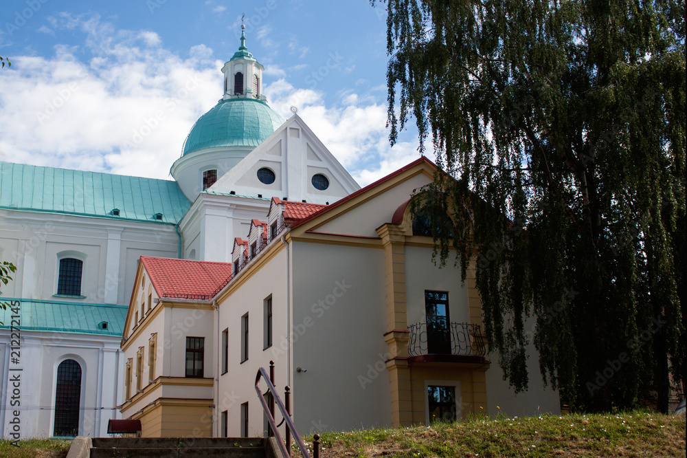 Sights and views of Grodno. Belarus. The cupolas of the church of the fair in the background of the blue sky and the building of the old city.