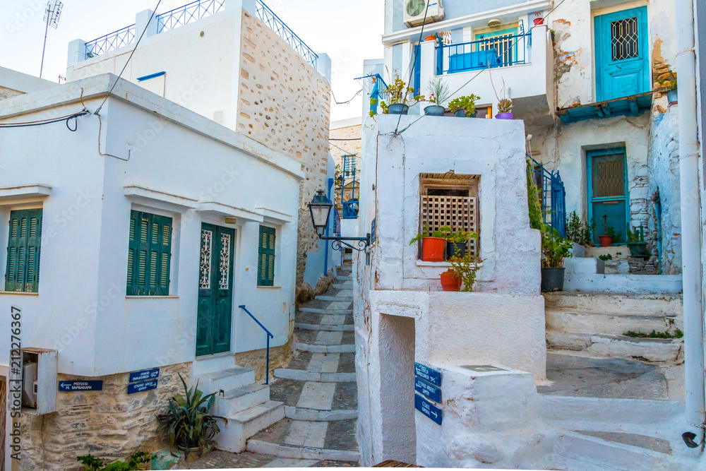 Fototapeta premium Paved narrow alley of Ano Syros in Syros island, Cyclades, Greece. Street view
