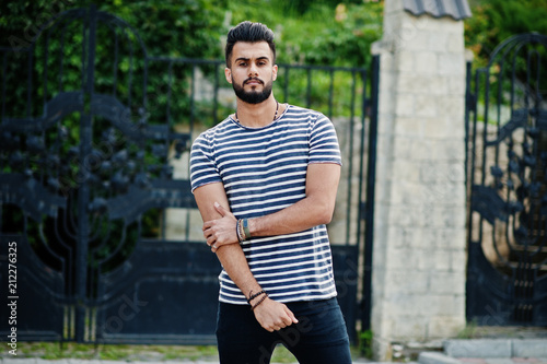 Handsome tall arabian beard man model at stripped shirt posed outdoor. Fashionable arab guy. © AS Photo Family