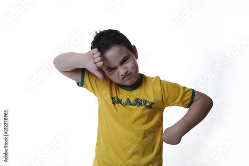 Sad boy with yellow soccer fan green shirt