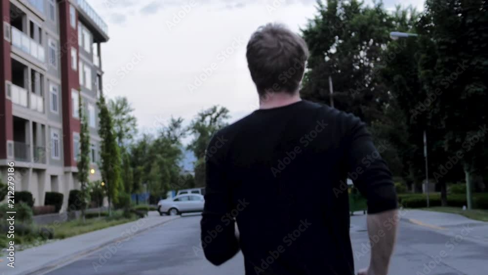 Slow Motion Man Jogging on Neighbourhood Street Slow Motion Man Jogging on Neighbourhood Street