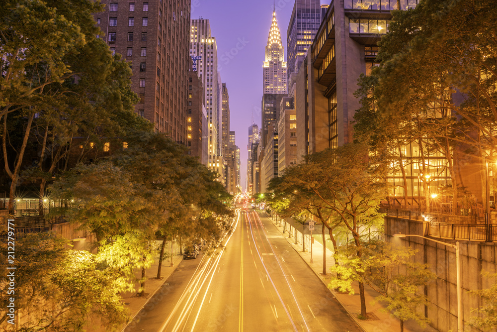 42nd street, Manhattan viewed from Tudor City Overpass at night featuring car light trails on the foreground