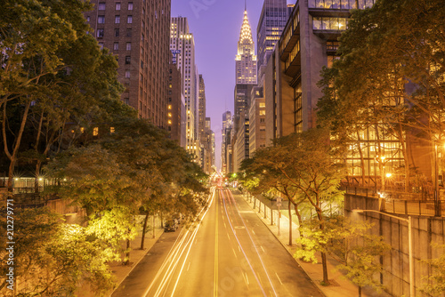 42nd street, Manhattan viewed from Tudor City Overpass at night featuring car light trails on the foreground photo