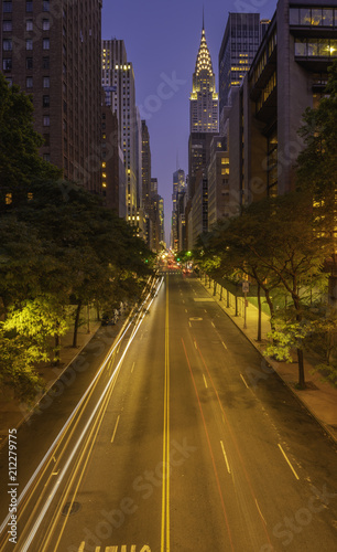42nd street, Manhattan viewed from Tudor City Overpass at night featuring car light trails on the foreground © TetyanaOhare