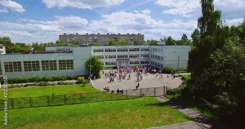 A large crowd of people in front of the school. Aerial view