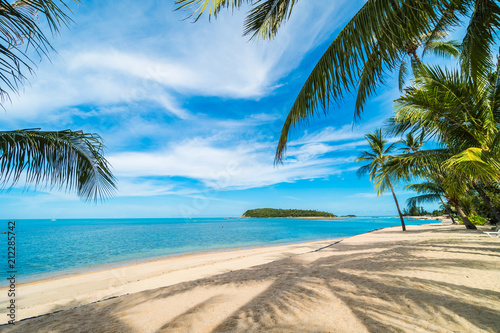 Fototapeta Naklejka Na Ścianę i Meble -  Beautiful tropical beach sea and sand with coconut palm tree on blue sky and white cloud