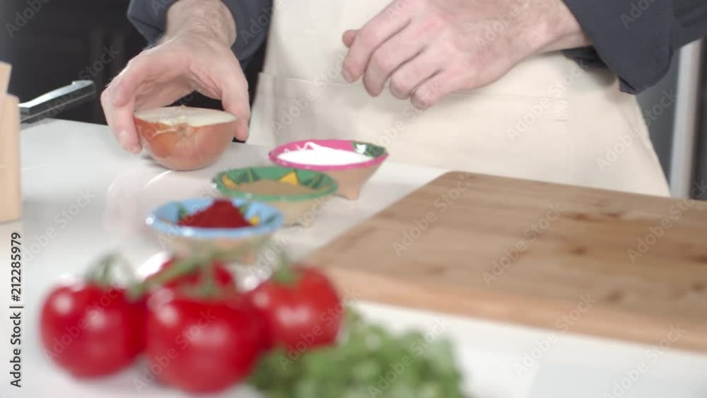 Chef peeling yellow onion in kitchen Chef peeling yellow onion in kitchen