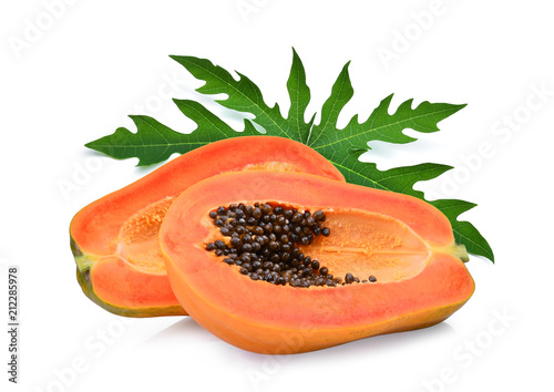 whole and half ripe papaya with green leaf isolated on white background