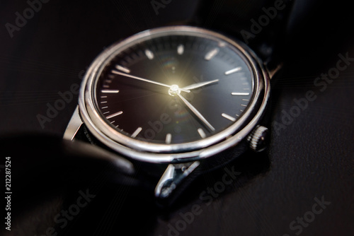 Quartz wristwatch with black dial close-up 
