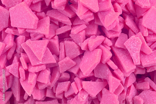 Candy background, copy space. Closeup of pile pastel chocolate candies. Candy texture. Candy pattern. Sweets background. Pink abstract background. Top view, flat lay