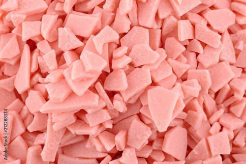 Candy background, copy space. Closeup of pile pastel chocolate candies. Candy texture. Food pattern. Sweets background. Coral abstract background. Top view, flat lay